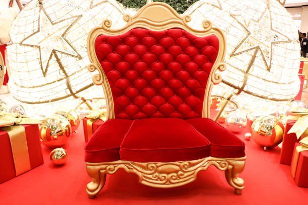 Luxurious red chair Santa Claus throne surrounded by multiple gift boxes